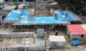 Atari Residences Ikoyi: 4 Premium Waterfront Homes 2 Overhead view of Atari Residence Ikoyi showing blue construction formwork, concrete columns, site workers, and the developing building footprint