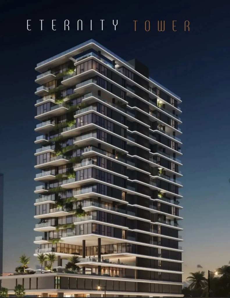 Eternity Tower Eko Atlantic | 32 Luxury Residences 2 Illuminated night view of Eternity Tower, Eko Atlantic City, Lagos, showing LED‑lit balconies with planted greenery, glass balustrades and palm trees at the base against a deep blue dusk sky.
