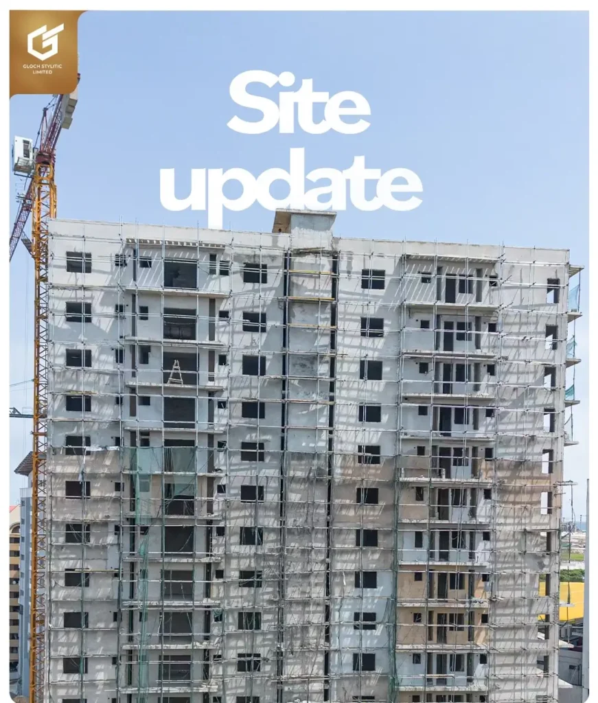 Gloch Tower Victoria Island construction site update showing the high-rise concrete structure wrapped in scaffolding with tower crane under a clear blue sky